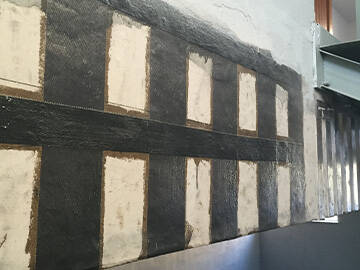 Rénovation d'un gymnase avec un tissu polymère renforcé de fibres de carbone